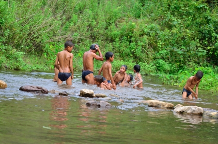 BAN  NAMLOW , VIANGPHOUKHA, LUANGNAMTHA , LAO P D R  MAY 31   Unidentified  group of  Akha  ethnic kids  7-12 years old are taking a bath  by Namlow river on May 31,2013  at  Ban namlow, Viangphoukha,Luangnamtha,Lao pdrのeditorial素材