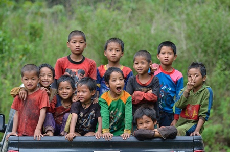 BAN  NAMLOW , VIANGPHOUKHA, LUANGNAMTHA , LAO P D R  MAY 31   Unidentified  group of  Akha  ethnic kids  7-12 years old smile to camera by Namlow river on May 31,2013  at  Ban namlow, Viangphoukha,Luangnamtha,Lao pdrのeditorial素材