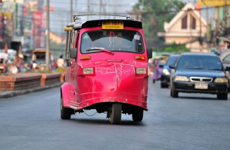 AYUTTHAYA,THAILAND - MARCH 18  A tuk tuk taxi transports passengers on  road in Ayutthaya province on March 18, 2013 in Ayutthaya, Thailand のeditorial素材