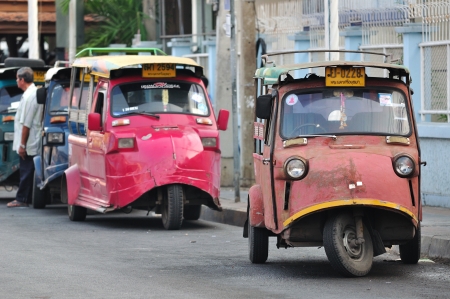AYUTTHAYA,THAILAND - MARCH 18  A tuk tuk taxi transports passengers on  road in Ayutthaya province on March 18, 2013 in Ayutthaya, Thailand のeditorial素材