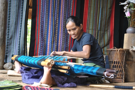 BA CHIENGCHALEUNSOOK ,Lao P D R -JULY 15 ;Unidentified woman is weaving  traditional strips on July 15,2010 in Ba chiengchaleunsook,Champasak,Lao p d r のeditorial素材