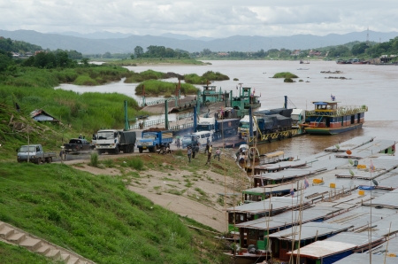 HOUAY XAI HARBOR,BOKEO,LAO PDR  JUNE 10 ; Unidentified trucks are driving from the ferry boat to Houay xai customs office on June 10,2013 at Houay xai harbor, Bokeo , Lao pdr のeditorial素材