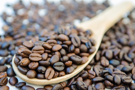 Coffee beans and wooden scoop の写真素材