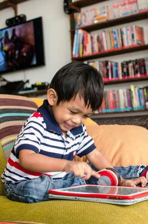 asian child playing with tablet