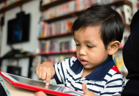 asian child playing with tablet