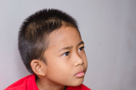 little boy looks seriouslyの写真素材