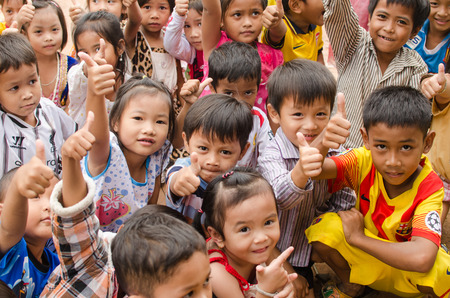 KAP CHOENG,SURIN,THAILAND-JULY 20  A group of happy Khmer kids are playing while their parents are...