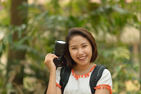cute asian girl with cameraの写真素材
