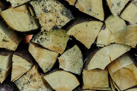 Dry firewood in a pile for furnace kindling firewood texture. Firewood stack. Staple of biomass...