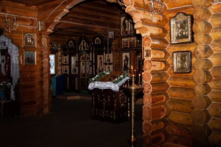 Moscow region, Russia, 01.22.2019. The interior of a wooden village Church decorated before the Christian feast of Baptism. Colorful icons hang on the walls of the temple.のeditorial素材