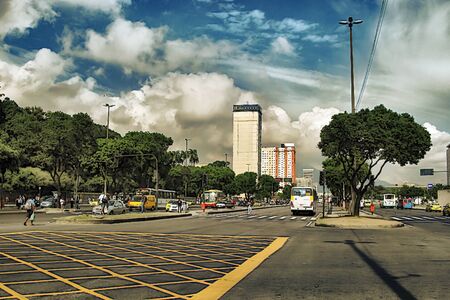 Rio de Janeiro, Brazil, 03.22.2018. An ordinary city street on a bright Sunny day. People walk past the intersection, buses and taxis go. Modern urban life in Brazil.のeditorial素材