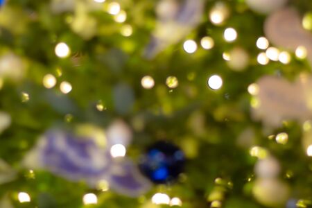 Colorful bokeh defocused Christmas garlands, Christmas fair. Festive abstract background.