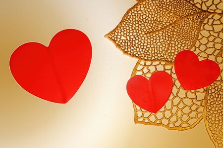 Golden background with red hearts. Love heart frame. Happy mother's day concept. Love symbol. Holiday card background, copy space for text.の写真素材