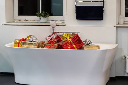 Group of gifts. Gift boxes with bows are stacked in the bath. Congratulations on a surprise...