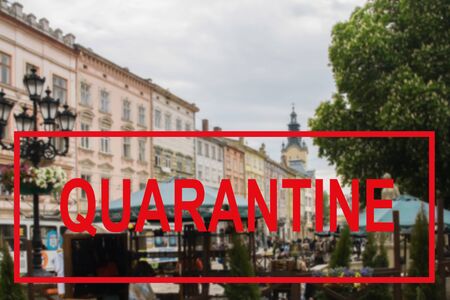Warning text about a coronavirus outbreak in Ukraine against a blurred background of the ancient architecture of the Ukrainian city of Lviv. Coronavirus and quarantine for travel and tourism, pandemic covid-2019の写真素材