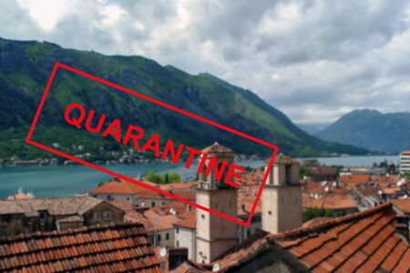 Text Quarantine on the background of the Mediterranean coast in Montenegro . The concept of a high probability of a new coronavirus outbreak in traveling touristsの写真素材