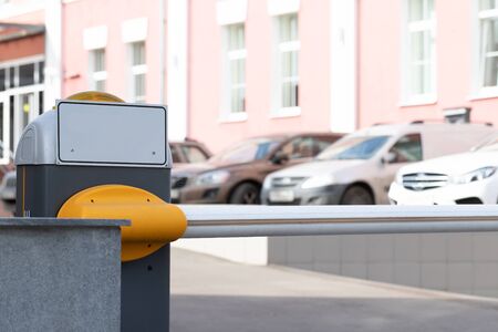 Automatic security metal barrier boom closed for stop and checking car entering to restricted area , placed at main entrance beside the road , selective focused, blurred background. Security concept or banの写真素材