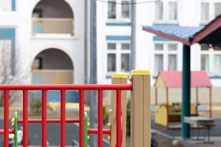 An empty Playground in a modern kindergarten on a Sunny spring day. Closed safe area for outdoor games for children. Selective focus, copy space for your text.の写真素材