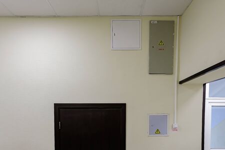A metal box and plastic boxes reliably protect the electrical wiring in a modern office building....