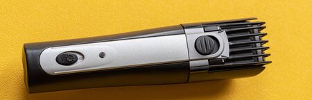 Shaver on a yellow background. The concept of a shaving machine.