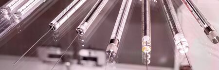 Close-up of glass syringe on light background. Monochrome toned image. Health care concept