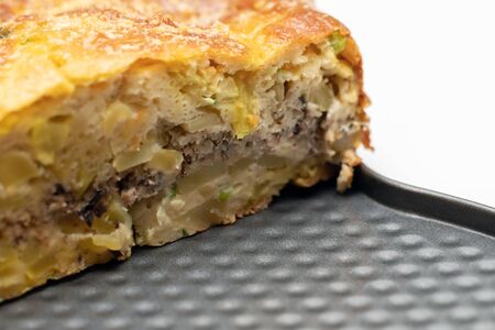Homemade yeast-free cake on kefir with a filling of canned fish and potatoes, close-up. A hearty dish for a Flexitarianの写真素材