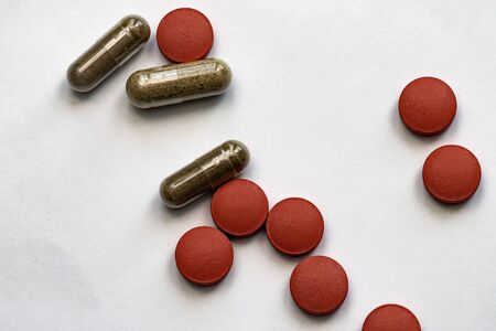 Different colorful tablets isolated on white background, close-up, selective focus