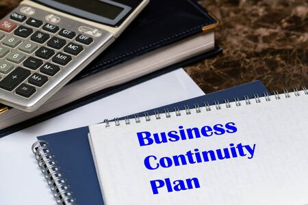 The text of the business continuity plan is written on a white sheet lying on the office Desk. Concept BCPの写真素材