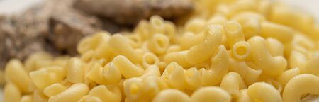 Chicken liver stewed in sour cream and a side dish of pasta in a bowl , close-up. healthy food, menu...