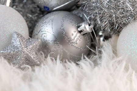 Poster with silver Christmas balls. Beautiful Christmas composition with copy space on a fluffy white fur background.の写真素材