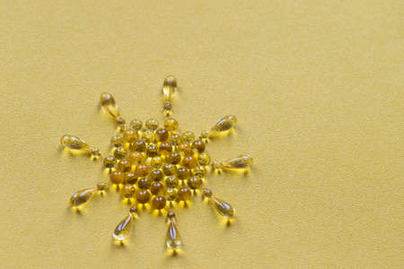 Fish Oil Capsules With Omega 3 And Vitamin D on a yellow background. Healthy vitamins. A copy space...
