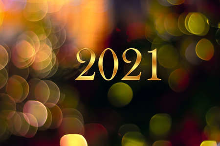 Happy New Year 2021. Numbers 2021 on abstract multicolored background of blurred bokeh of garland...
