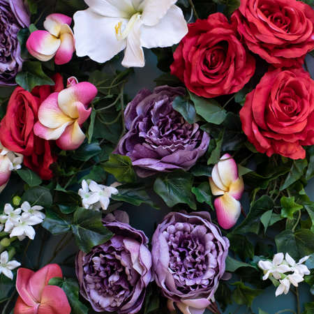 Background from large bright flowers from paper. Red roses, lilac peonies, white lilies and pink...