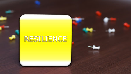 RESILIENCE. Text on the background of the table and scattered pushpins.の写真素材