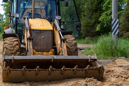Bulldozer builds road. Grader in a new highaway construction. CONSTRUCTION MACHINERY.
