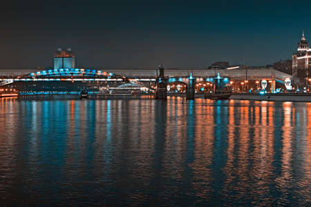 Toned image of the city at night. Evening city lights are reflected in the water. Russia, Moscowの写真素材