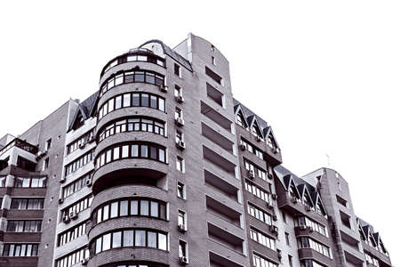 Facade of a high-rise apartment building. Typical city development. Multi-storey residential building in a big city. Vintage toning.の写真素材