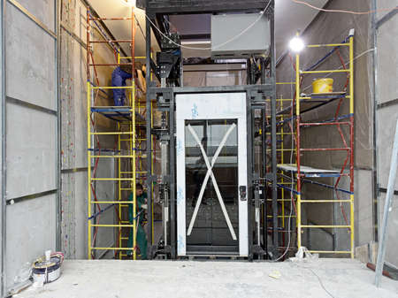 Moscow, Russia, 12.02.2021 Installation and assembly of a high-speed elevator in a modern skyscraper...