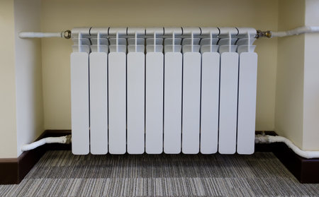 Modern heating batteries. White warm radiator. Concept of the need for good central heating.の写真素材