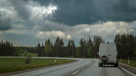 Small truck driving on an asphalt road. Small truck delivering goods