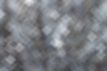 Silver defocused Lights on gray background for Christmas holiday seasonal wallpaper decoration...