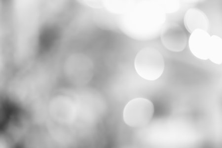 Silver defocused Lights on gray background for Christmas holiday seasonal wallpaper decoration greeting and wedding invitation card design elementの写真素材