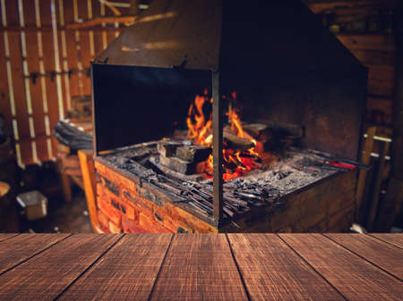 Interior of an old forge. Bright fire burning in the furnace. Forge fire used for creating iron...