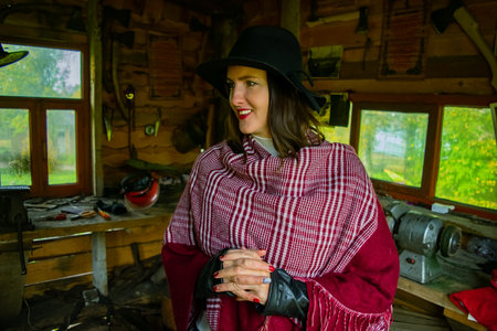 woman in blacksmith shop. Interior of an old forge.の写真素材