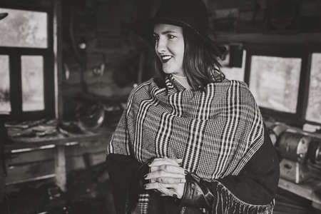 woman in blacksmith shop. Interior of an old forge. black and white image