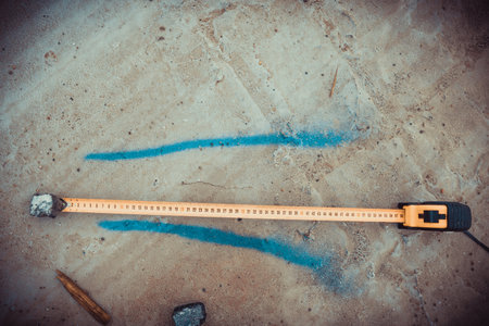 Measuring ruler on a concrete wall texture. The concept of renovation, repair or construction.の写真素材