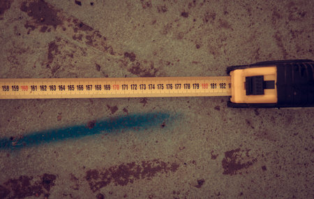 Measuring ruler on a concrete wall texture. The concept of renovation, repair or construction.の写真素材