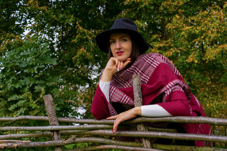 portrait of a smiling happy woman against the backdrop of an autumn landscape. positive emotions. Unity with nature. autumn landscape. Happy moments.の写真素材