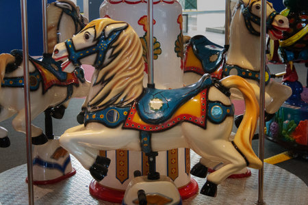 Old children's carousel with a horse close-up. Flying toy animals in entertainment parkの写真素材