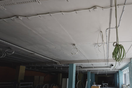 Installation of electrical wiring on the ceiling. Electrical cable system installation. Electrical...